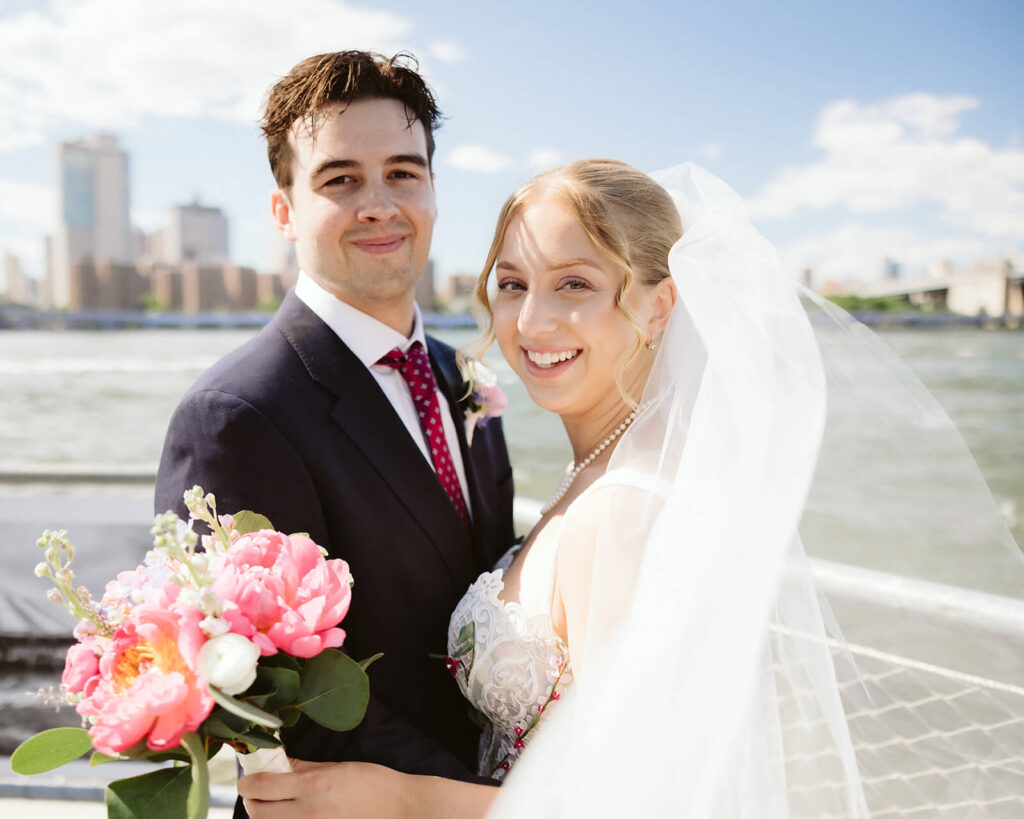 Bride and groom portraits along a  the waterfront in Brooklyn Bridge Park. Photo by OkCrowe Photography. 