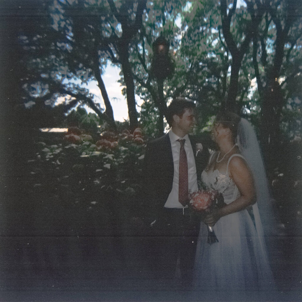 Bride and groom portraits along a  forested path in Brooklyn Bridge Park. Photo by OkCrowe Photography. 