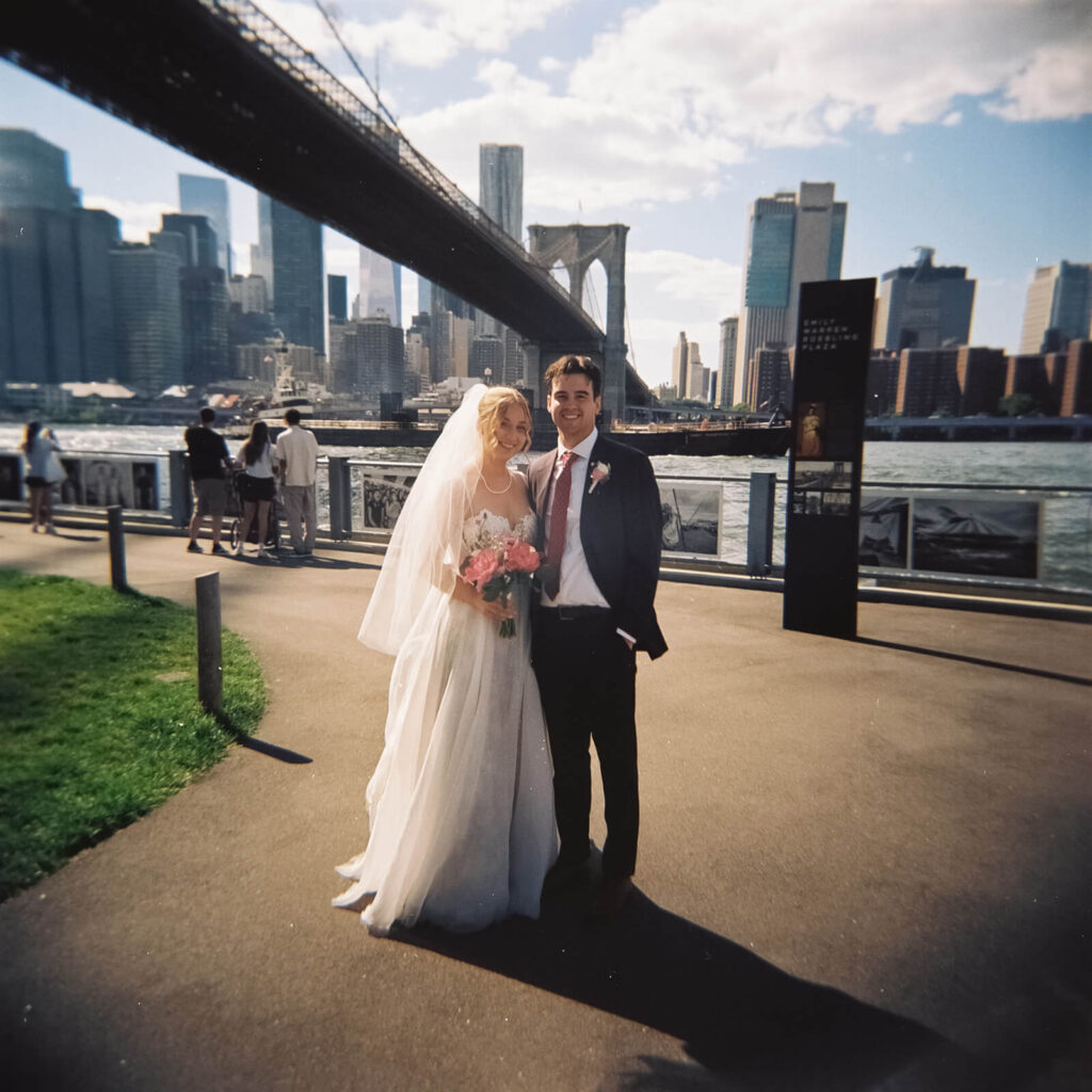 Bride and groom portraits along a  the waterfront in Brooklyn Bridge Park. Photo by OkCrowe Photography. 