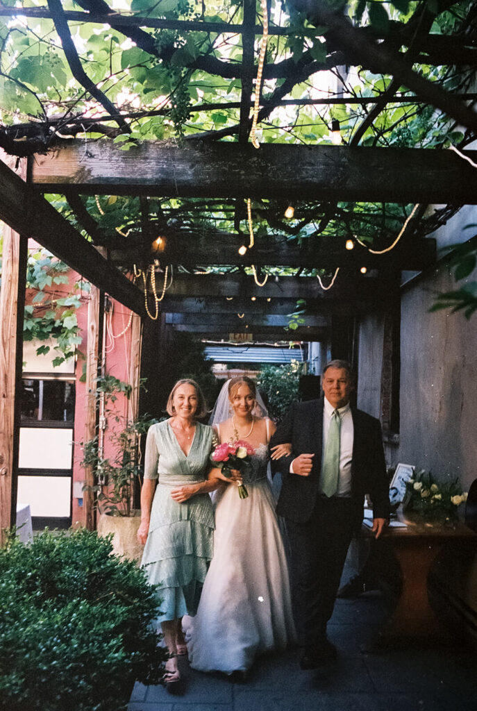 Backyard-style wedding ceremony in Frankies Spuntino's outdoor Garden space. Photo by OkCrowe Photography.