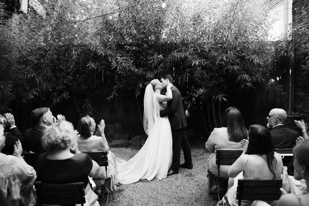 Backyard-style wedding ceremony in Frankies Spuntino's outdoor Garden space. Photo by OkCrowe Photography.