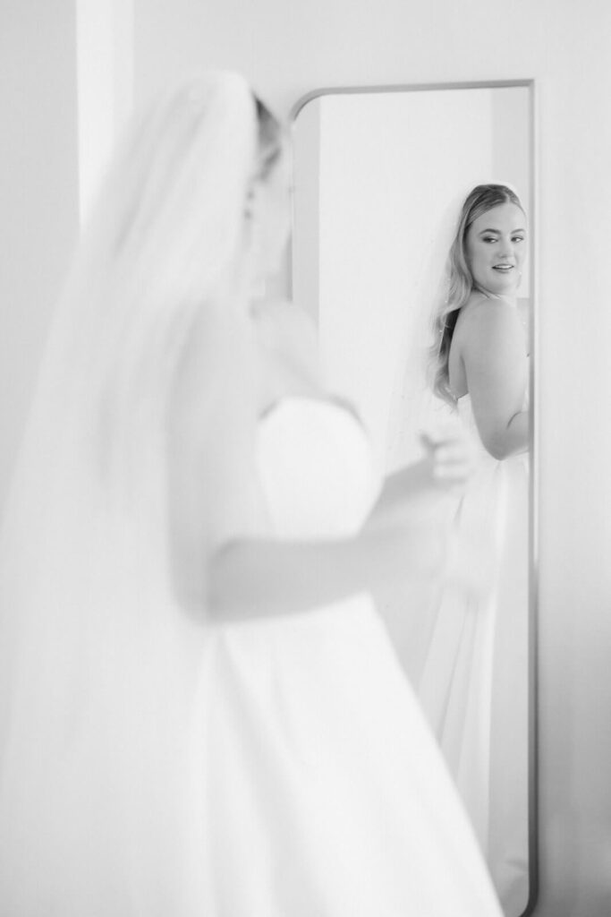 Bride getting ready in an AirBnB for a wedding at the New York Botanical Gardens. Photo by OkCrowe Photography.