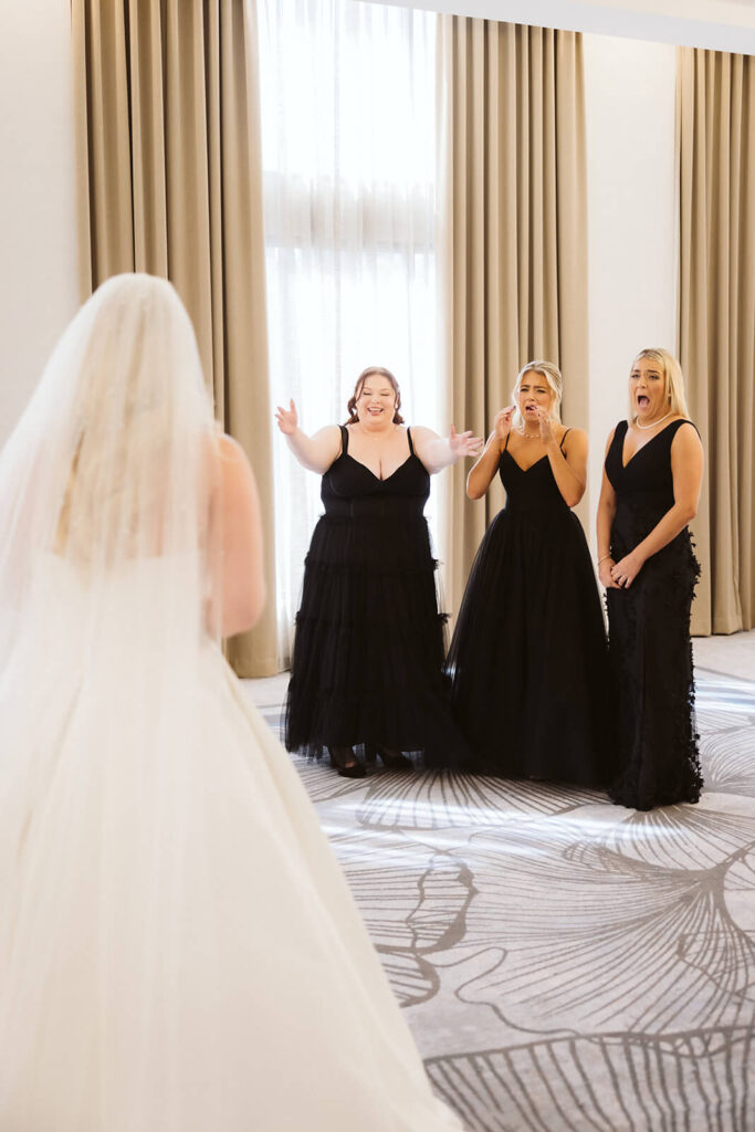 Bridesmaids First Look in an AirBnB for a wedding at the New York Botanical Gardens. Photo by OkCrowe Photography.