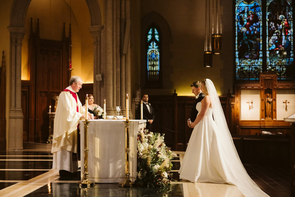 Wedding ceremony at the Fordham University Church. Photo by OkCrowe Photography.