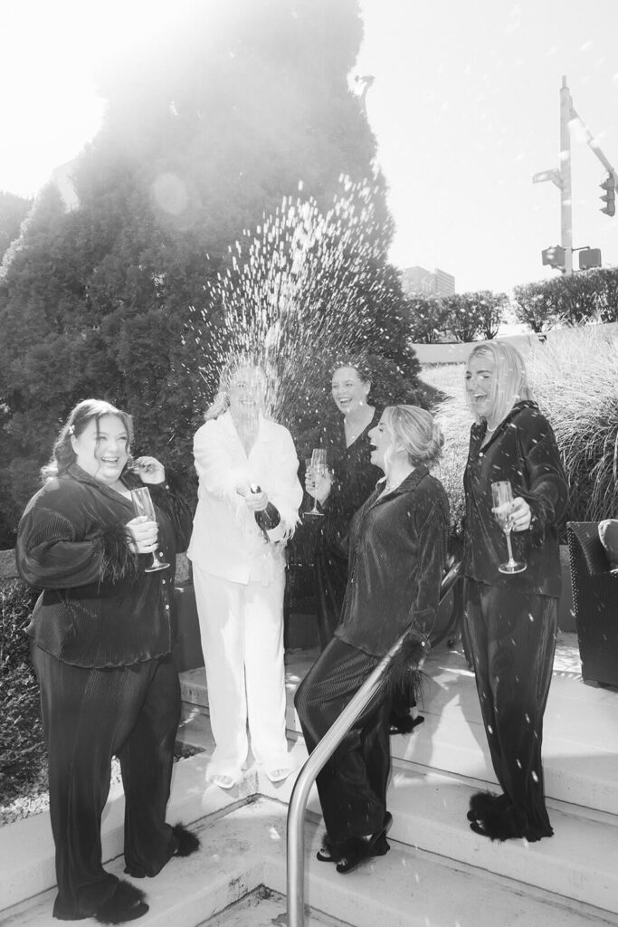 Bride and her bridesmaids getting ready in an AirBnB for a wedding at the New York Botanical Gardens. Photo by OkCrowe Photography.