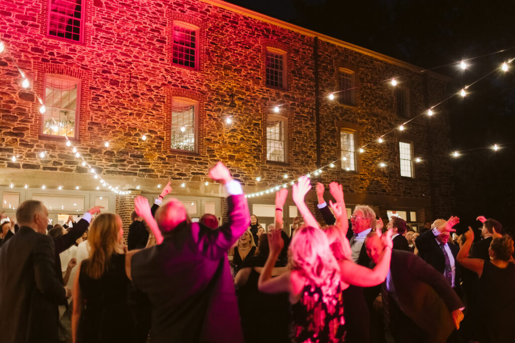 Dance floor of a wedding reception at the Stone Mill in the New York Botanical Gardens. Photo by OkCrowe Photography.