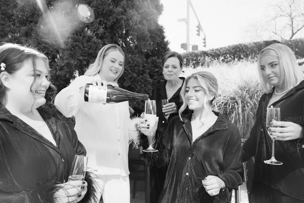 Bride and her bridesmaids getting ready in an AirBnB for a wedding at the New York Botanical Gardens. Photo by OkCrowe Photography.