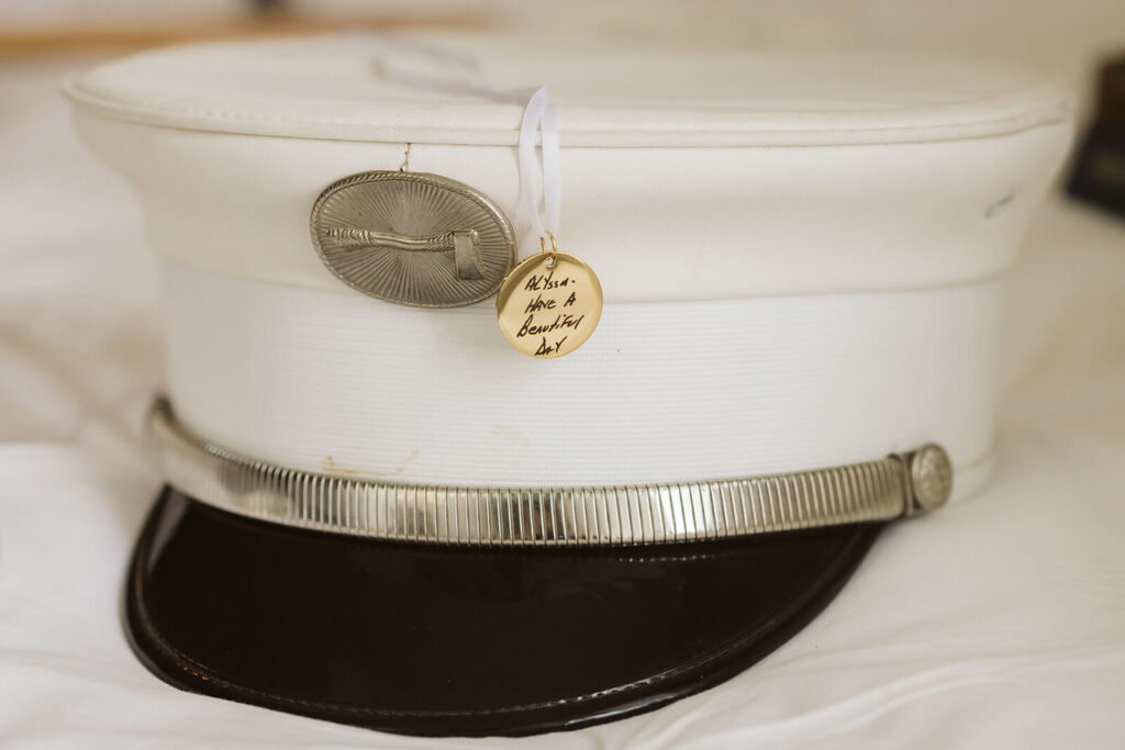 Charms on a military hat in honor of bride's late father. Photo by OkCrowe Photography. 