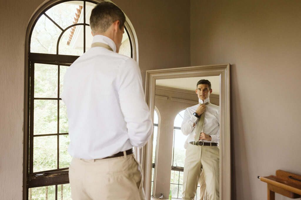 Groom getting ready at Arrow Park. Photo by OkCrowe Photography.