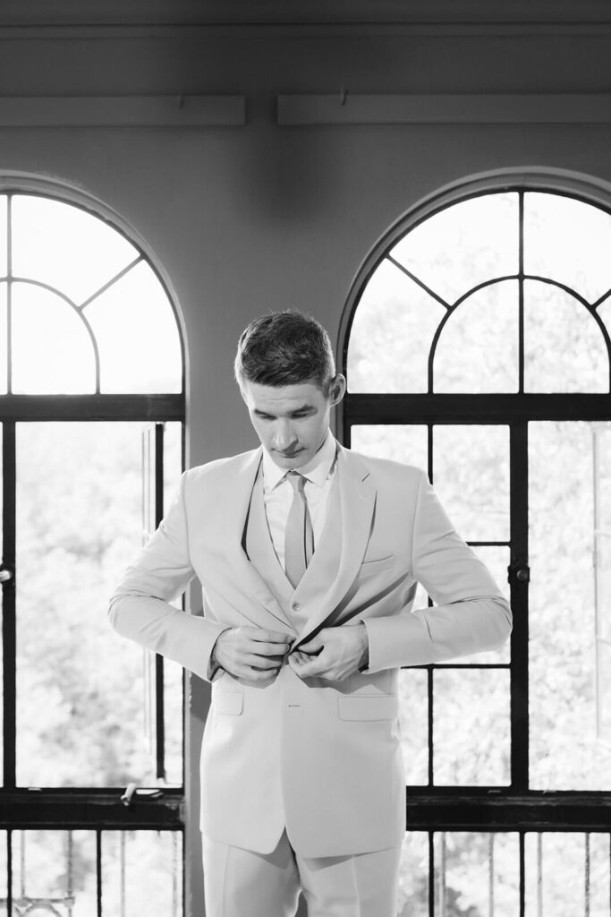 Groom getting ready at Arrow Park. Photo by OkCrowe Photography.