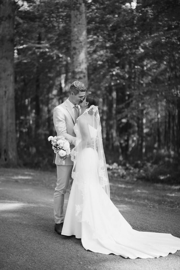 Bride and groom first look along a tree-lined road at Arrow Park. Photo by OkCrowe Photography.  