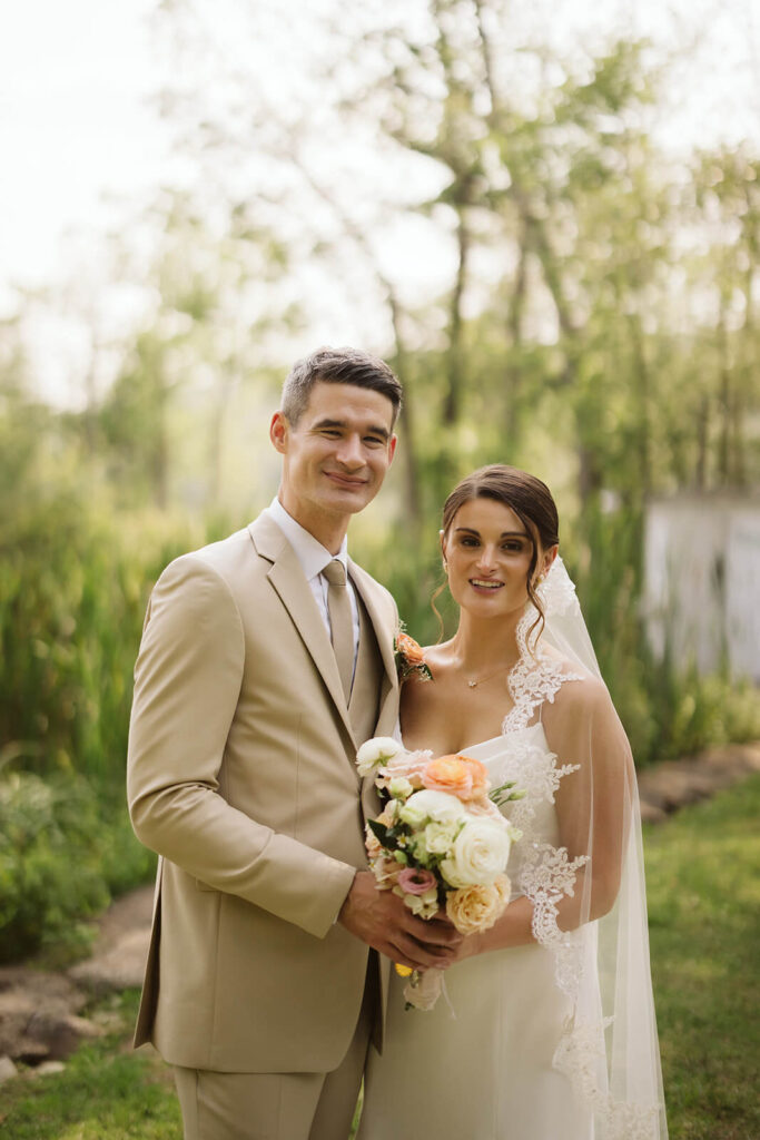 Bride and groom portraits by the lake at Arrow Park. Photo by OkCrowe Photography.  