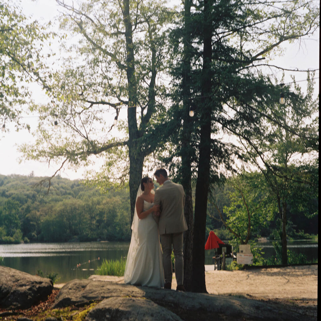 Bride and groom portraits by the lake at Arrow Park. Photo by OkCrowe Photography.  