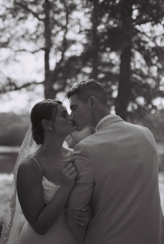 Bride and groom portraits by the lake at Arrow Park. Photo by OkCrowe Photography.  