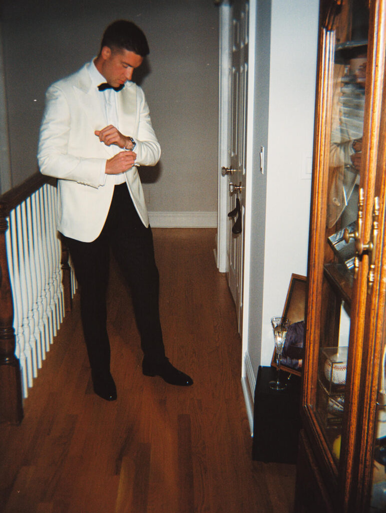 Groom getting ready in the bride's parents' home. Photo by OkCrowe Photography. 