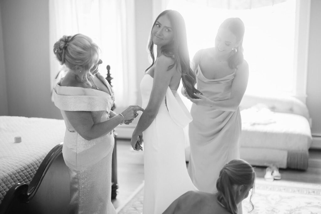 Bride and bridesmaids getting ready for her wedding in her parents' home. Photo by OkCrowe Photography. 
