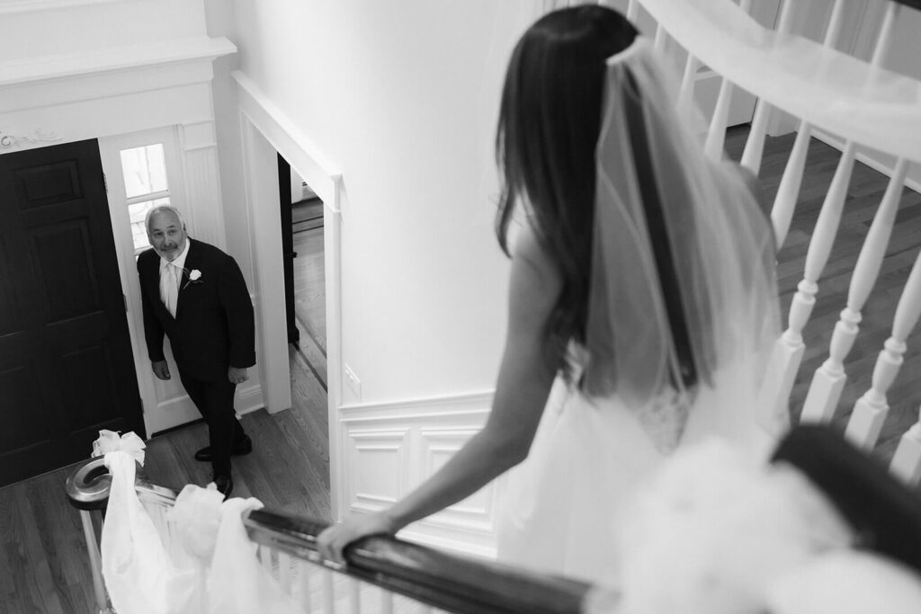 Father-daughter first look in the bride's childhood home. Photo by OkCrowe Photography. 