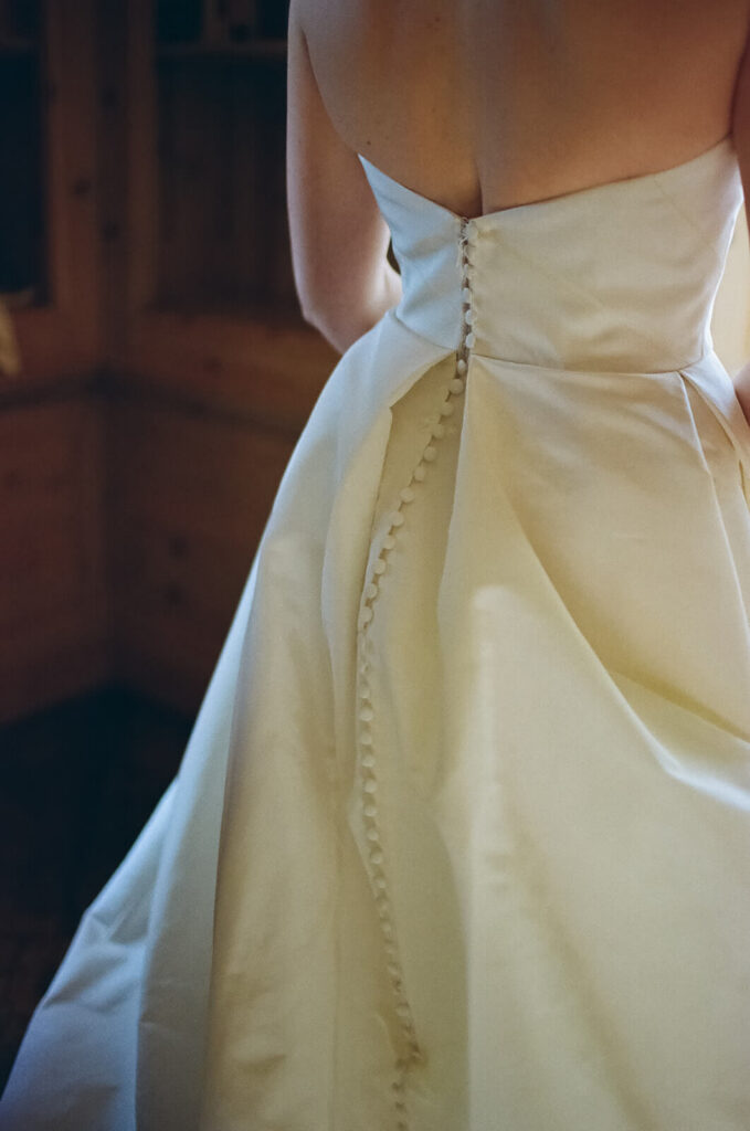 Bride's wedding gown details in the TPC Jasna Polana Prince Albert Suite. Photo by OkCrowe Photography.