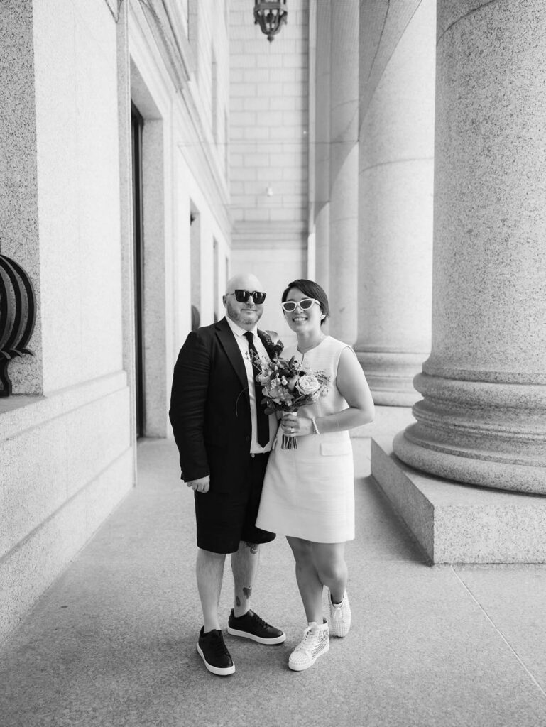 Newlyweds portraits after their courthouse ceremony leaving the NYC Courthouse. Photo by OkCrowe Photography.