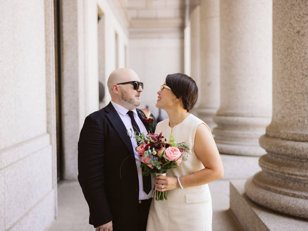 Newlyweds portraits after their courthouse ceremony leaving the NYC Courthouse. Photo by OkCrowe Photography.