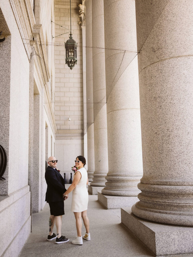 Newlyweds portraits after their courthouse ceremony leaving the NYC Courthouse. Photo by OkCrowe Photography.
