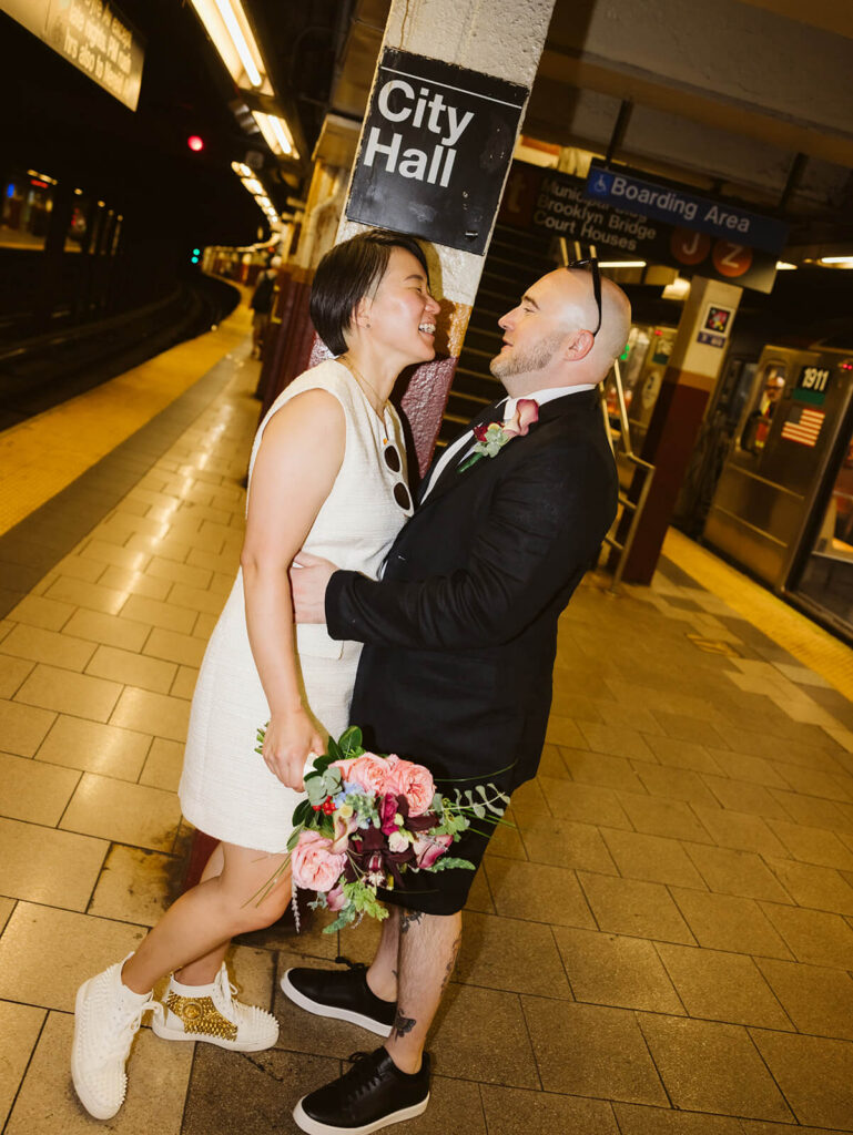 Newlyweds portraits after their courthouse ceremony at the NYC Courthouse subway station. Photo by OkCrowe Photography.