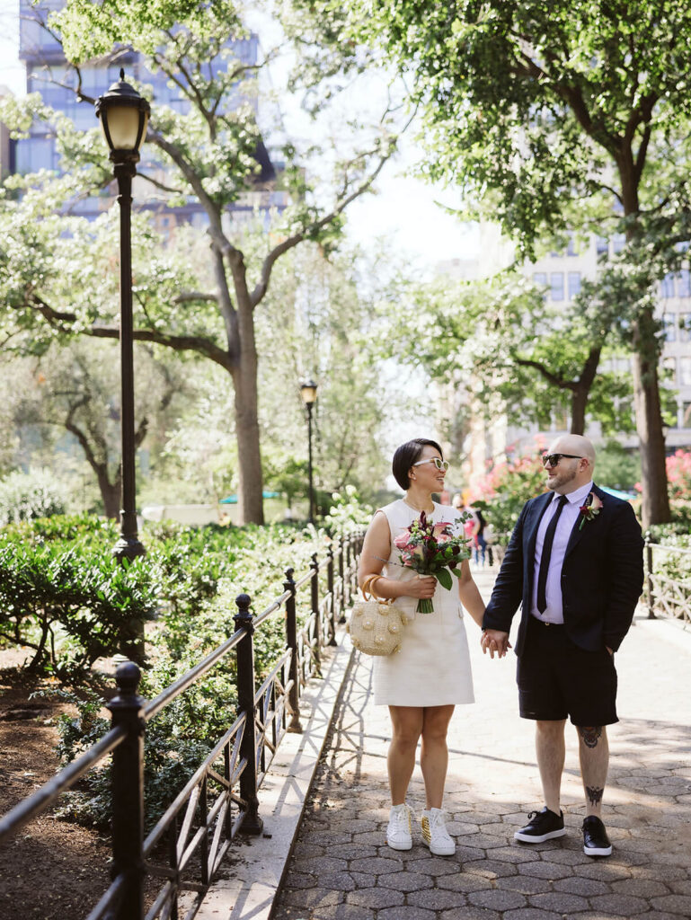 Newlyweds portraits at the Greenmarket in Union Square Park after their courthouse ceremony at the NYC Courthouse. Photo by OkCrowe Photography.
