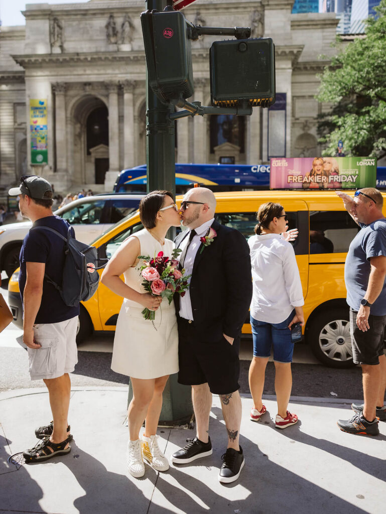 Newlyweds portraits outside the New York Public Library after their courthouse ceremony at the NYC Courthouse. Photo by OkCrowe Photography.