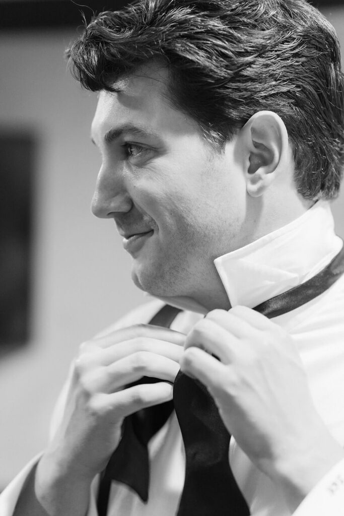 Groom getting ready in the cocktail lounge at the Mansion at Oyster Bay. Photo by OkCrowe Photography.