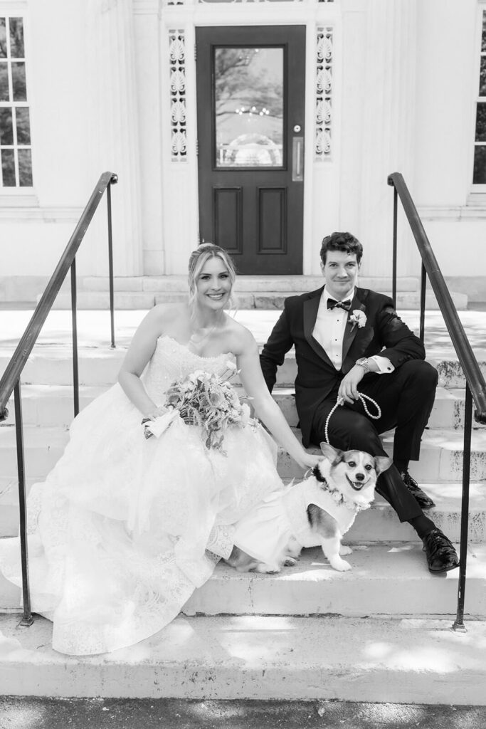 Bride and groom with their dog at the entrance to the Mansion at Oyster Bay. Photo by OkCrowe Photography.