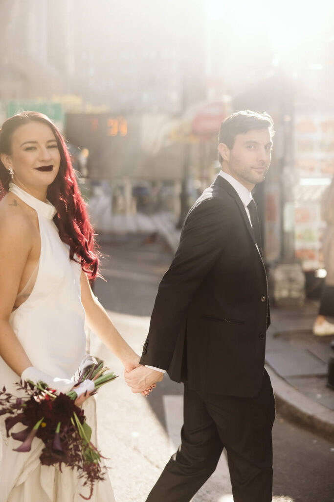 Newlywed photos walking through the streets of NYC. Photo by OkCrowe Photography.