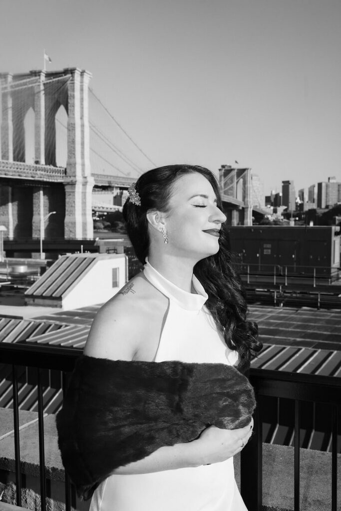 Newlywed photos on the balcony of the 33 Seaport Hotel Brooklyn Bridge Grand Terrace Suite. Photo by OkCrowe Photography.