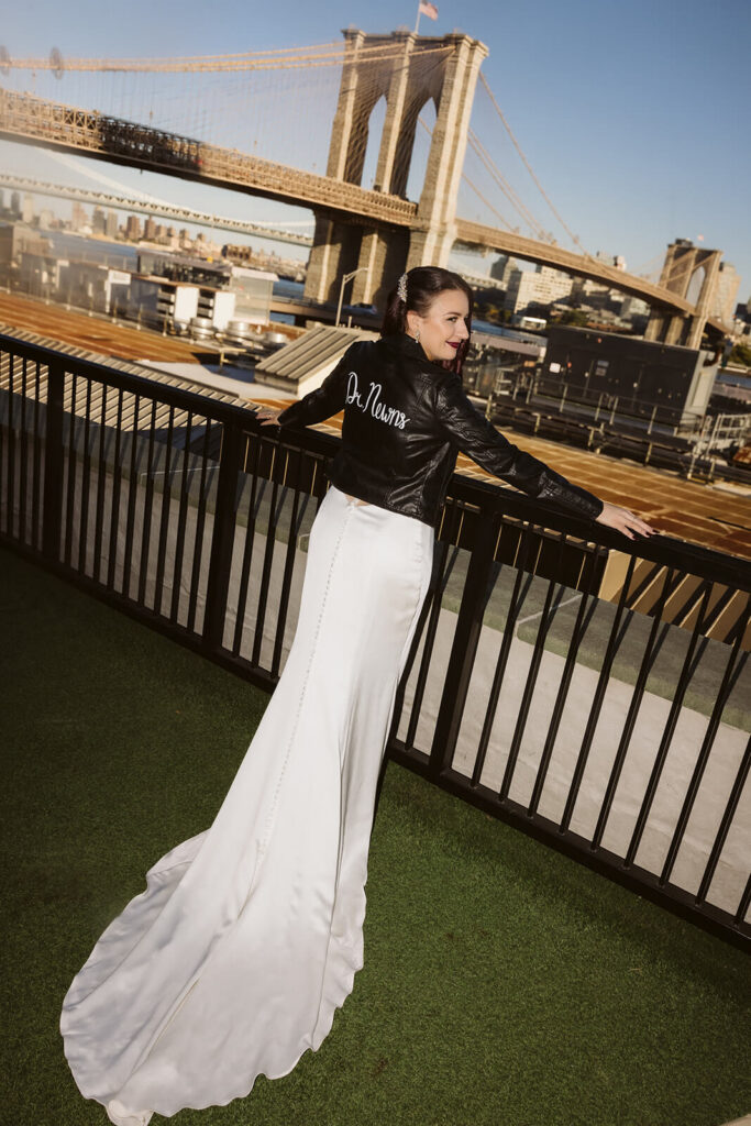 Newlywed photos on the balcony of the 33 Seaport Hotel Brooklyn Bridge Grand Terrace Suite. Photo by OkCrowe Photography.
