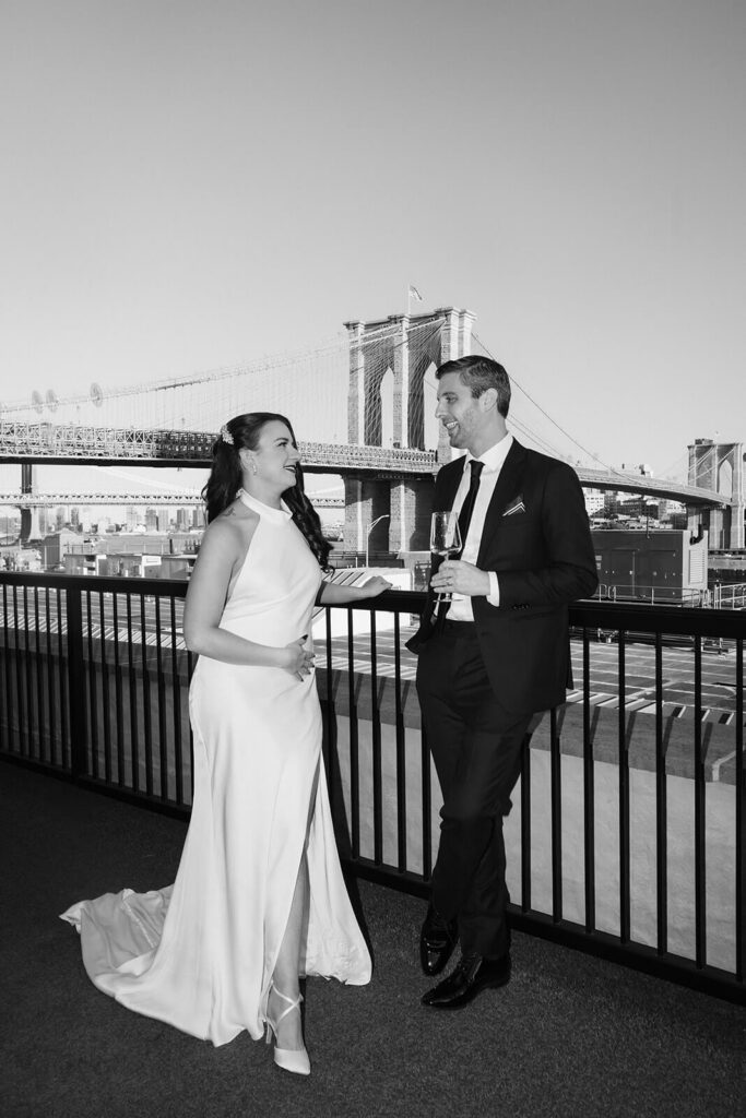 Newlywed photos on the balcony of the 33 Seaport Hotel Brooklyn Bridge Grand Terrace Suite. Photo by OkCrowe Photography.