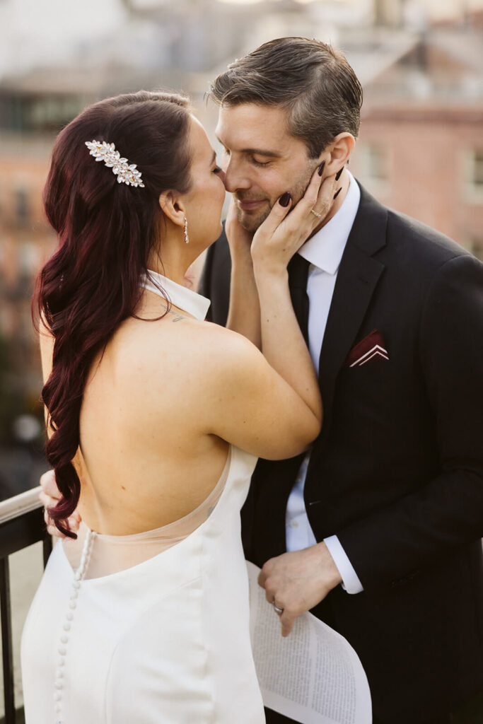 Newlywed photos on the balcony of the 33 Seaport Hotel Brooklyn Bridge Grand Terrace Suite. Photo by OkCrowe Photography.