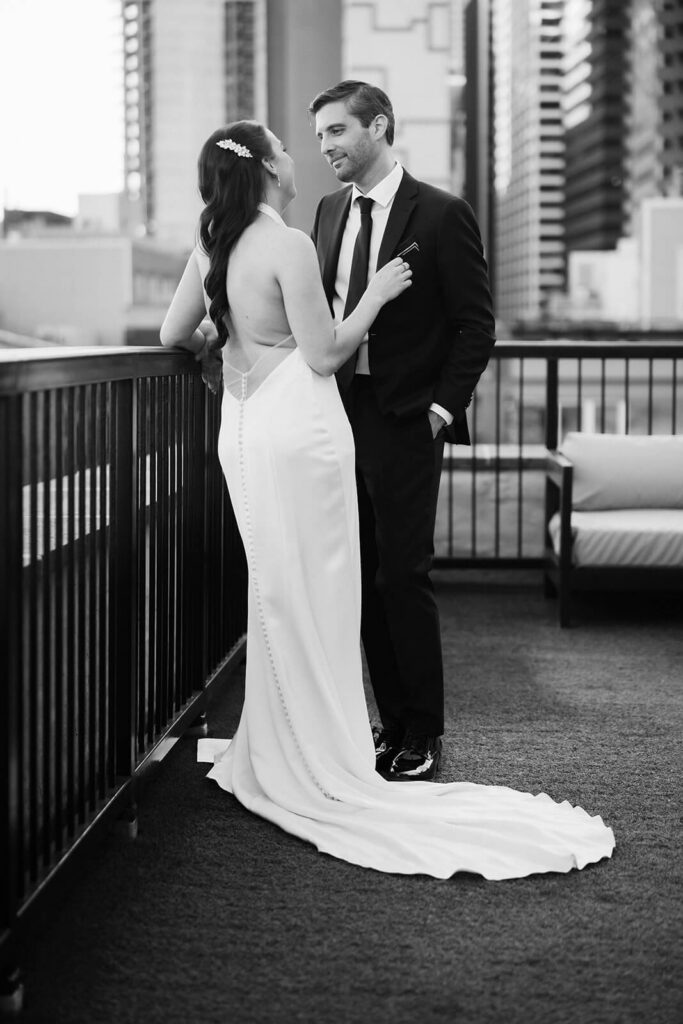 Newlywed photos on the balcony of the 33 Seaport Hotel Brooklyn Bridge Grand Terrace Suite. Photo by OkCrowe Photography.
