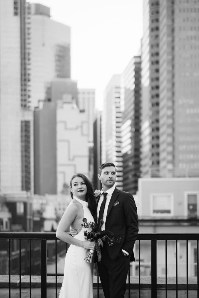Newlywed photos on the balcony of the 33 Seaport Hotel Brooklyn Bridge Grand Terrace Suite. Photo by OkCrowe Photography.