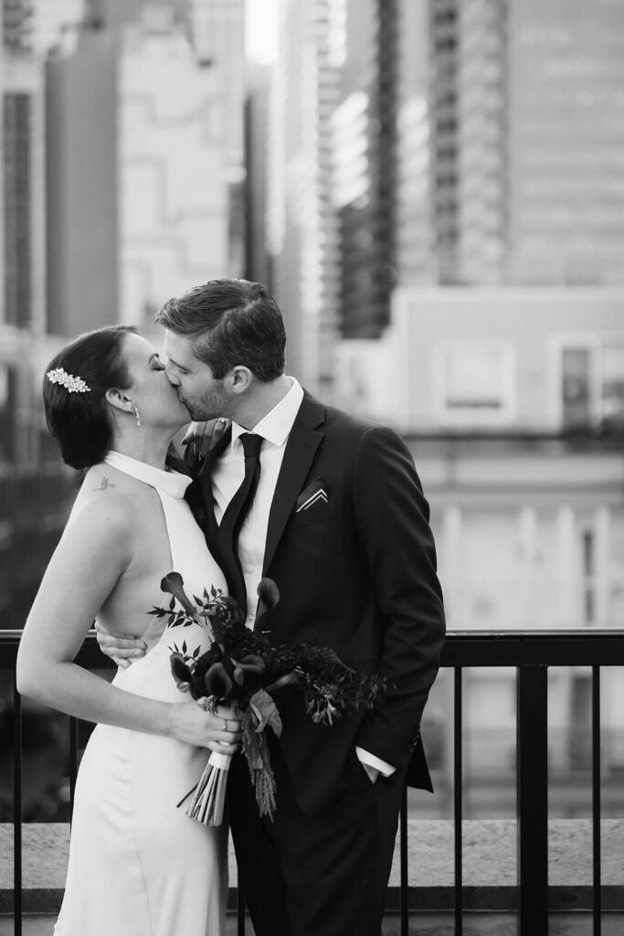 Newlywed photos on the balcony of the 33 Seaport Hotel Brooklyn Bridge Grand Terrace Suite. Photo by OkCrowe Photography.