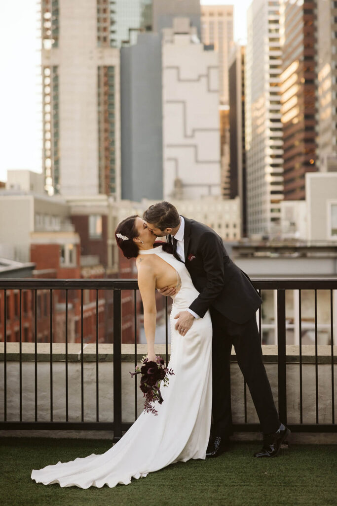 Newlywed photos on the balcony of the 33 Seaport Hotel Brooklyn Bridge Grand Terrace Suite. Photo by OkCrowe Photography.