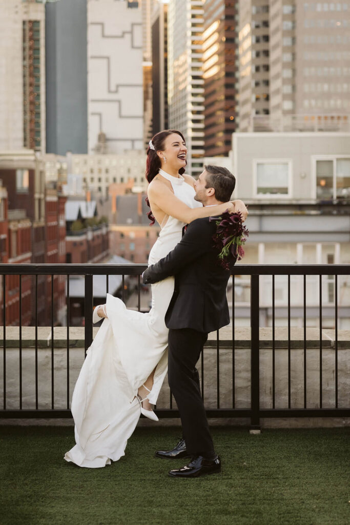 Newlywed photos on the balcony of the 33 Seaport Hotel Brooklyn Bridge Grand Terrace Suite. Photo by OkCrowe Photography.