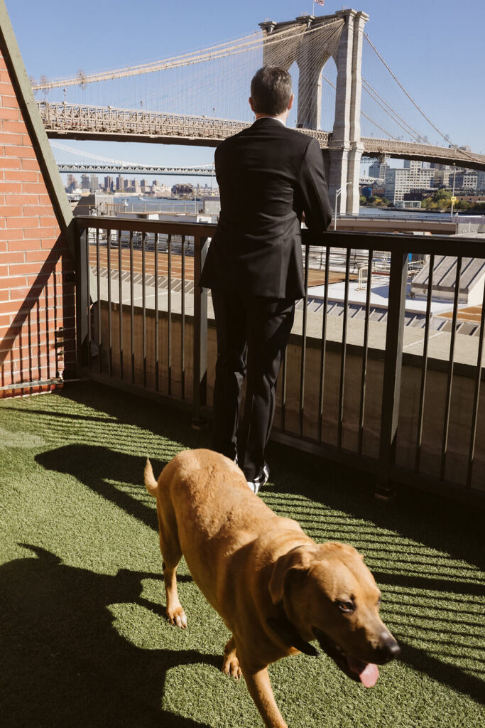 Groom waiting on the balcony of the 33 Seaport Hotel waiting for their first look. Photo by OkCrowe Photography.